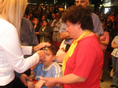 Vassula praying over a child who is physically challenged