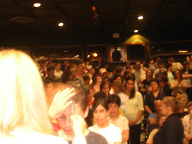 Vassula praying over the children lining up 